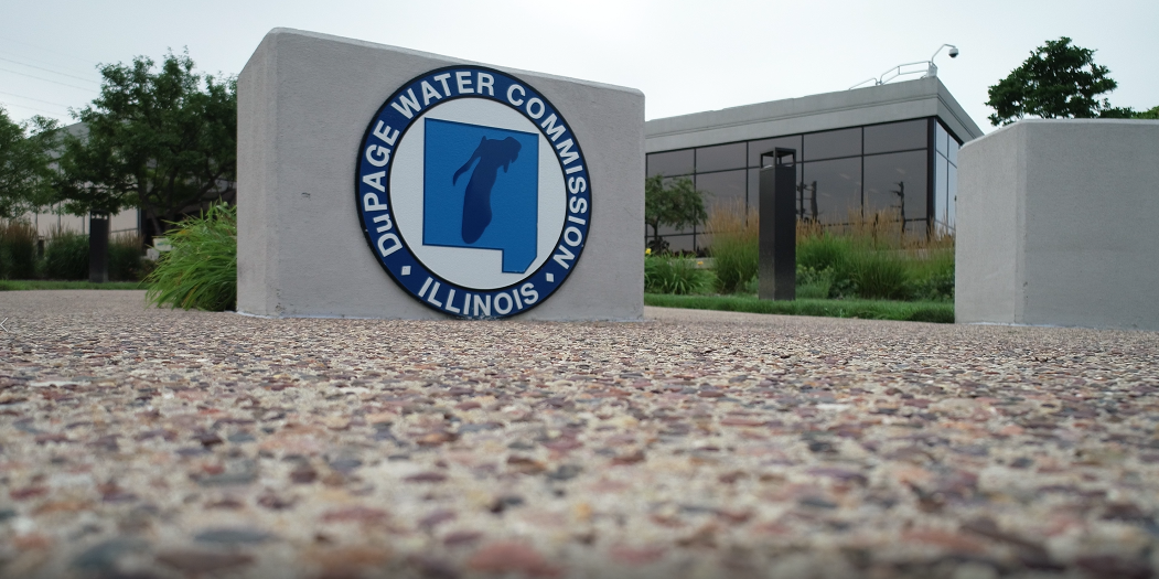 closeup image of DWC logo set on stone pillar